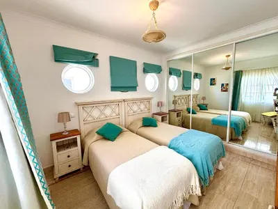 a bedroom with two beds and a mirror at Casa da Luz 9 , golf view townhouse in Vila do Bispo