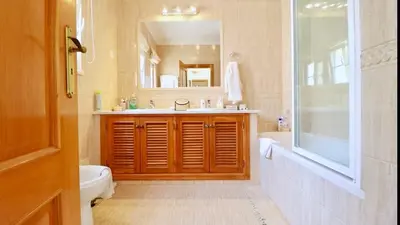 a bathroom with a sink and a tub and a toilet at Casa da Luz 9 , golf view townhouse in Vila do Bispo