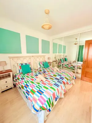 a bedroom with two beds and a large mirror at Casa da Luz 9 , golf view townhouse in Vila do Bispo