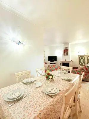 a dining room with a table with plates and napkins at Casa da Luz 9 , golf view townhouse in Vila do Bispo