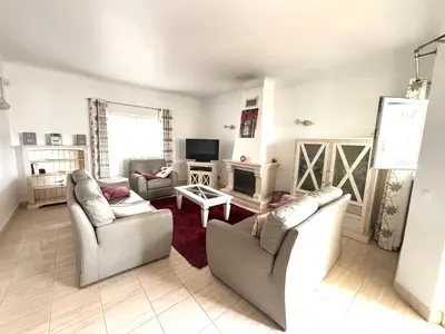 a living room with two couches and a tv at Casa da Luz 9 , golf view townhouse in Vila do Bispo