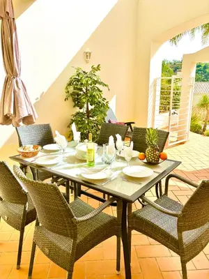 a dining room with a table and chairs at Casa da Luz 9 , golf view townhouse in Vila do Bispo