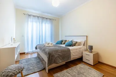 a bedroom with a bed and a window at Cantinho da Ribeira in Machico