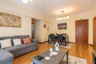 a living room with a couch and a table at Cantinho da Ribeira in Machico
