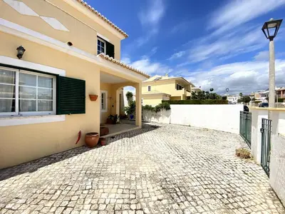 a house with a brick driveway in front of it at Porto de Mós Family House in Lagos