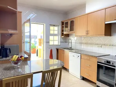 a kitchen with a bowl of fruit on a counter at Porto de Mós Family House in Lagos