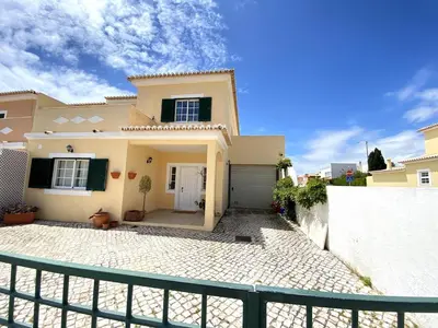 a large house with a fence in front of it at Porto de Mós Family House in Lagos