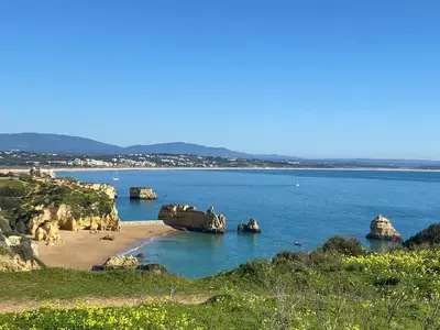 a view of a beach with rocks in the water at Porto de Mós Family House in Lagos