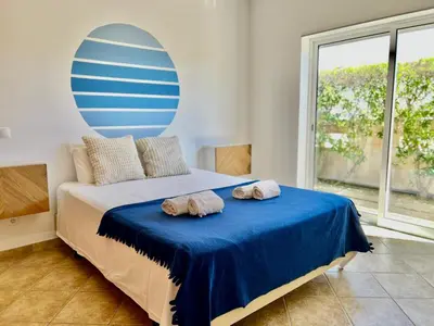 a bedroom with a bed with two towels on it at Salty & Swell Apartment in Sagres