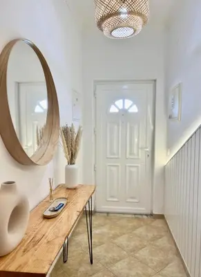 a hallway with a table and a mirror at Salty & Swell Apartment in Sagres