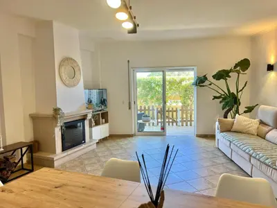 a living room with a couch and a table at Salty & Swell Apartment in Sagres