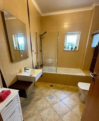 a bathroom with a sink and a tub and a toilet at Salty & Swell Apartment in Sagres