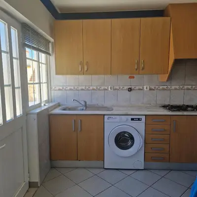 a kitchen with a washing machine and a sink at Apartamento T1 -Sagres in Sagres