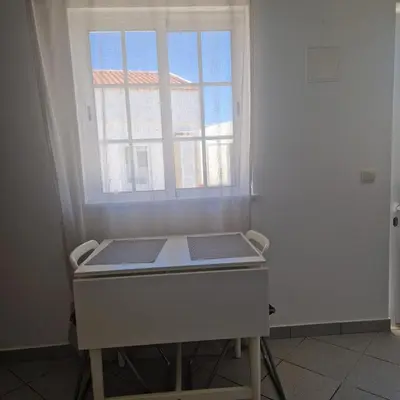 a room with a table in front of a window at Apartamento T1 -Sagres in Sagres