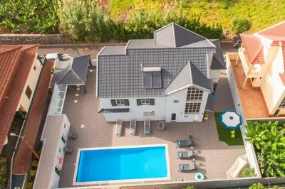 an aerial view of a house with a swimming pool at Villa Salinas in Paul do Mar