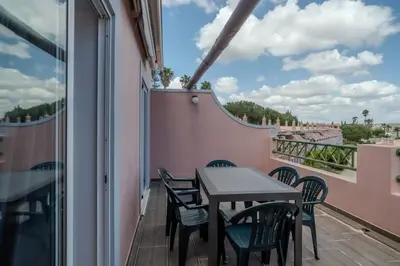 a table and chairs on a balcony with a view at Ocean View with Private Terrace in Luz