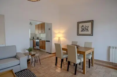 a living room with a dining room table and a couch at Ocean View with Private Terrace in Luz