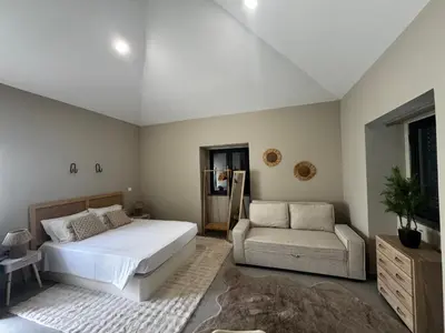 a bedroom with a bed and a couch and a chair at São Pedro Paradise A UP in Funchal
