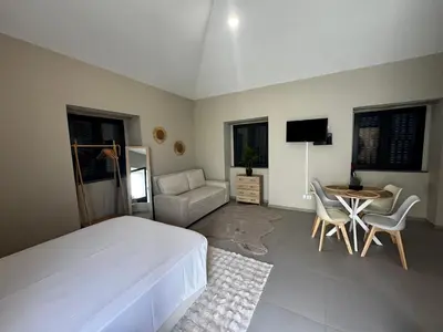 a bedroom with a bed and a table and chairs at São Pedro Paradise A UP in Funchal