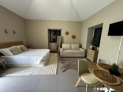 a bedroom with a bed and a couch and a table at São Pedro Paradise A UP in Funchal