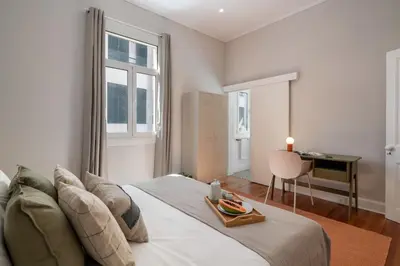 a bedroom with a large bed with a tray on it at Quintinha Estrelícia - Pool and Garden in Funchal