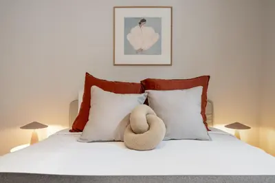 a teddy bear sitting on top of a bed at Quintinha Estrelícia - Pool and Garden in Funchal