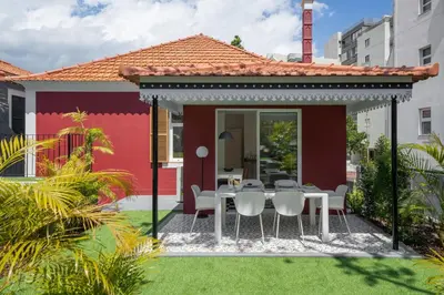 a dining area in a house with a table and chairs at Quintinha Estrelícia - Pool and Garden in Funchal