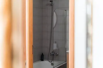 a bathroom with a shower with a tub at GuestReady- Charming Condo with Pool in Caniço in Caniço