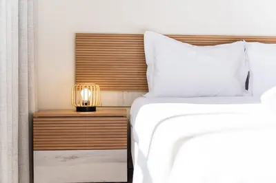 a bedroom with a bed and a lamp on a night stand at GuestReady- Charming Condo with Pool in Caniço in Caniço