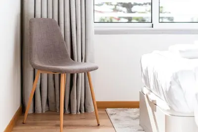 a chair sitting in front of a window at GuestReady- Charming Condo with Pool in Caniço in Caniço