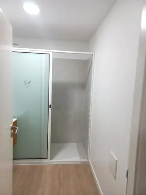 a shower with a glass door in a bathroom at Casa Martins in São Vicente