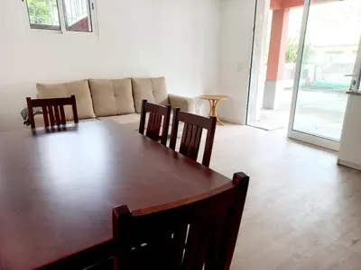 a table with a bunch of fruits and bottles of wine at Casa Martins in São Vicente