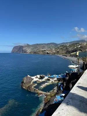 a small island in the ocean next to a beach at Varandas do Sol - Private Sun Terrace close to Natural Pools & Praia Formosa in Funchal