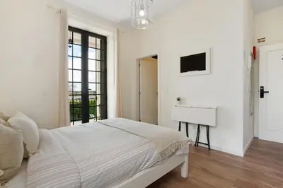 a kitchen with white cabinets and a sink at Vila Francisco in Funchal
