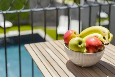 a balcony with a table and a bowl of fruit on it at Vila Francisco in Funchal