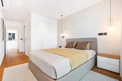 a bedroom with a large bed and white walls at Panoramic Bay and Sea Views - Luxury 3-Bed Flat in Funchal