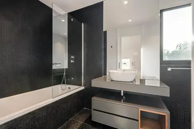 a bathroom with a sink and a mirror at Panoramic Bay and Sea Views - Luxury 3-Bed Flat in Funchal