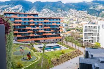 an aerial view of a building with a playground at Panoramic Bay and Sea Views - Luxury 3-Bed Flat in Funchal