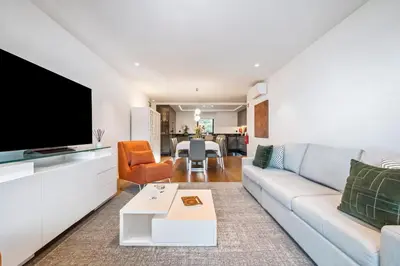 a living room with a couch and a tv at Panoramic Bay and Sea Views - Luxury 3-Bed Flat in Funchal