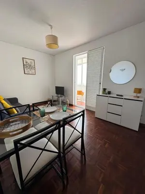 a living room with a table and a dining room at América Apartment Holiday in Funchal