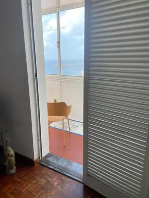 a door to a room with a view of the ocean at América Apartment Holiday in Funchal