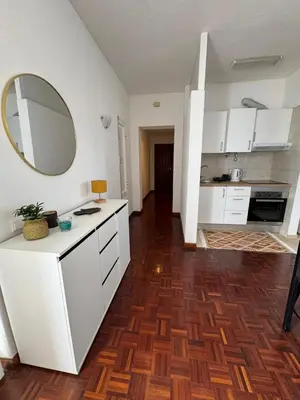 a kitchen with white cabinets and a mirror on the wall at América Apartment Holiday in Funchal