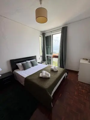 a bedroom with a bed with two towels on it at América Apartment Holiday in Funchal