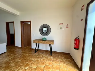 a room with a table and a mirror on a wall at Anita & Leonel's House A in Gaula