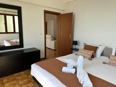 a bedroom with a large bed with towels on it at Anita & Leonel's House A in Gaula
