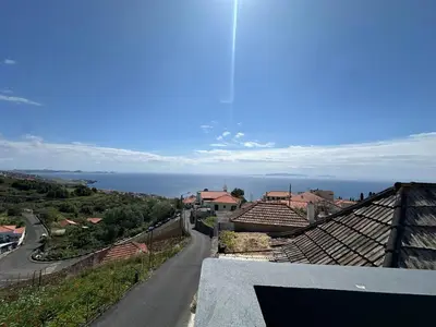 a view of a town with a road and the ocean at Anita & Leonel's House A in Gaula