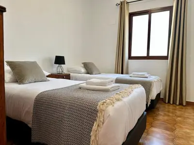 two beds in a room with a window at Anita & Leonel's House A in Gaula