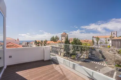 a balcony with a view of a city at Madeira Rooftop Studio, Ocean & City View in Funchal
