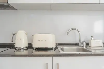 a kitchen counter with two toasters on a sink at Madeira Rooftop Studio, Ocean & City View in Funchal