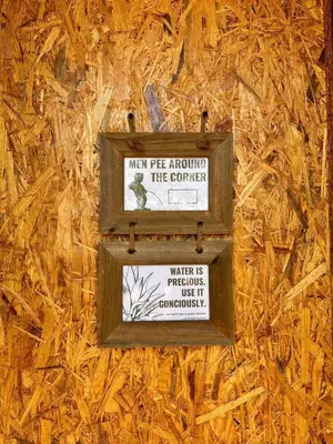 a sign on the side of a wall at Michas caravan for 2 See the herd of horses from your bed in Barão de São João